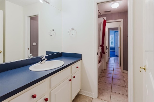 1852 Longview Ln, Tarpon Springs, FL 34689 - bathroom with vanity, tile patterned flooring, baseboards, and shower / bath combination with curtain