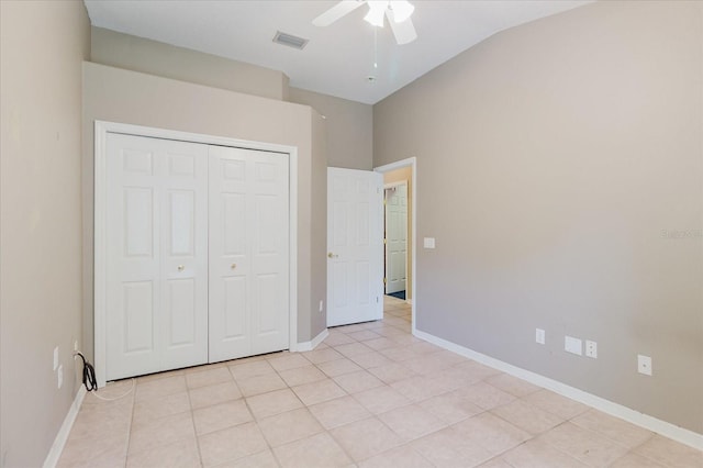 1852 Longview Ln, Tarpon Springs, FL 34689 - unfurnished bedroom with light tile patterned flooring, vaulted ceiling, a closet, baseboards, and ceiling fan