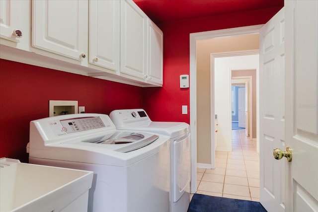 1852 Longview Ln, Tarpon Springs, FL 34689 - laundry room featuring washing machine and clothes dryer, light tile patterned floors, cabinet space, and baseboards