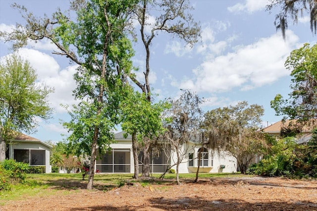 1852 Longview Ln, Tarpon Springs, FL 34689 - rear view of property with a sunroom