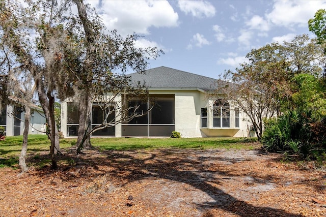 1852 Longview Ln, Tarpon Springs, FL 34689 - rear view of house with stucco siding and a sunroom