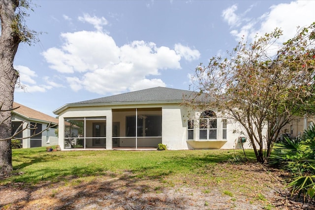 1852 Longview Ln, Tarpon Springs, FL 34689 - back of house featuring stucco siding, a yard, and a sunroom