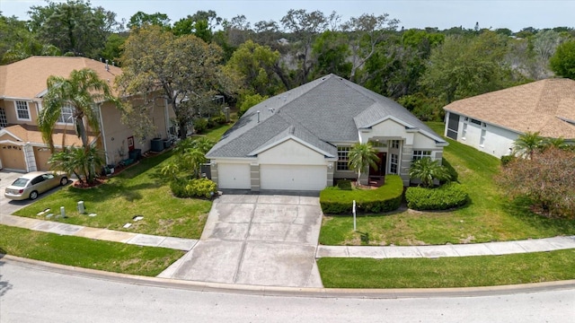 1852 Longview Ln, Tarpon Springs, FL 34689 - view of front facade featuring driveway, a garage, and a front yard