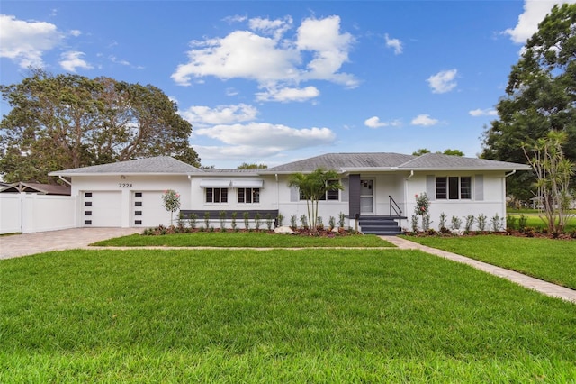 7224 Park St S, St Pete Beach, FL 33707 - single story home with stucco siding, an attached garage, and driveway