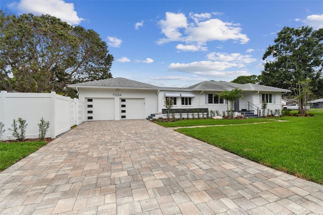 7224 Park St S, St Pete Beach, FL 33707 - view of front of house featuring decorative driveway, an attached garage, and stucco siding
