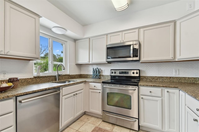 7224 Park St S, St Pete Beach, FL 33707 - kitchen featuring appliances with stainless steel finishes, a sink, tasteful backsplash, and light tile patterned floors