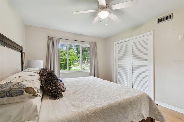 7224 Park St S, St Pete Beach, FL 33707 - bedroom featuring wood finished floors, a closet, baseboards, and ceiling fan