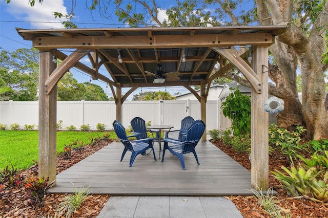 7224 Park St S, St Pete Beach, FL 33707 - wooden deck with a gazebo, ceiling fan, a fenced backyard, and outdoor dining space