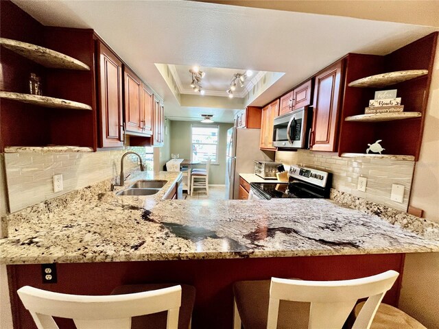 2131 Ridge Rd S Unit 76, Largo, FL 33778 - kitchen with open shelves, stainless steel microwave, electric range oven, crown molding, and a peninsula