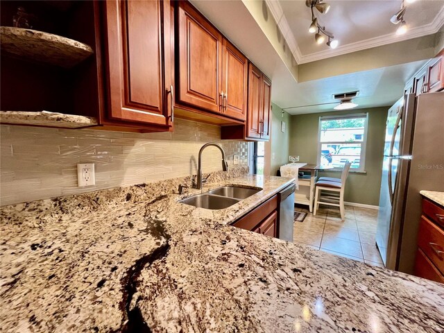 2131 Ridge Rd S Unit 76, Largo, FL 33778 - kitchen featuring a sink, appliances with stainless steel finishes, ornamental molding, tasteful backsplash, and brown cabinetry