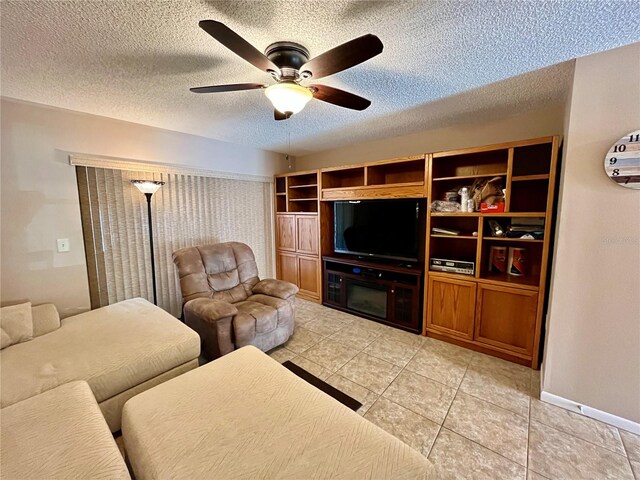 2131 Ridge Rd S Unit 76, Largo, FL 33778 - living room featuring ceiling fan, a textured ceiling, light tile patterned floors, and baseboards