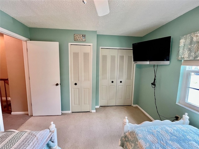 2131 Ridge Rd S Unit 76, Largo, FL 33778 - carpeted bedroom featuring multiple closets, baseboards, a textured ceiling, and a ceiling fan