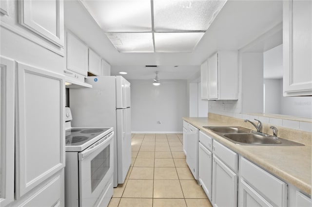 7330 Abalone Dr, Port Richey, FL 34668 - kitchen featuring white appliances, under cabinet range hood, white cabinets, light tile patterned floors, and light countertops