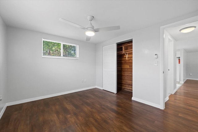7330 Abalone Dr, Port Richey, FL 34668 - unfurnished bedroom featuring dark wood finished floors, a closet, and a ceiling fan