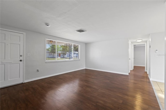 7330 Abalone Dr, Port Richey, FL 34668 - empty room with wood finished floors and a smoke detector