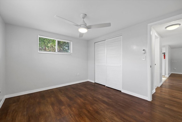 7330 Abalone Dr, Port Richey, FL 34668 - unfurnished bedroom with a closet, dark wood-style flooring, and ceiling fan
