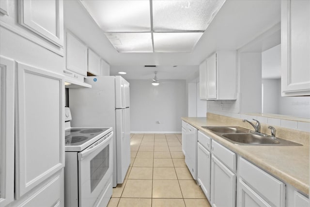 7330 Abalone Dr, Port Richey, FL 34668 - kitchen featuring white appliances, under cabinet range hood, white cabinetry, light tile patterned floors, and light countertops