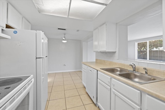 7330 Abalone Dr, Port Richey, FL 34668 - kitchen featuring white dishwasher, white cabinetry, light tile patterned floors, and light countertops