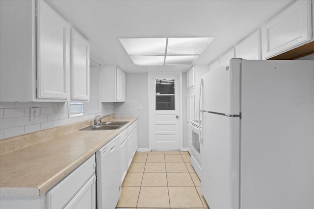 7330 Abalone Dr, Port Richey, FL 34668 - kitchen featuring white appliances, white cabinetry, light tile patterned flooring, and light countertops