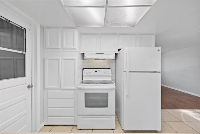 7330 Abalone Dr, Port Richey, FL 34668 - kitchen featuring white appliances, under cabinet range hood, light tile patterned floors, white cabinets, and decorative backsplash