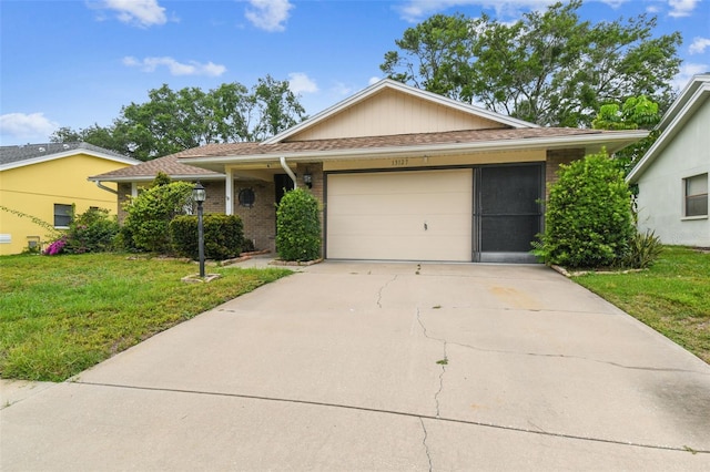 13127 Topflite Ct, Hudson, FL 34669 - single story home with a front yard, concrete driveway, a garage, and brick siding