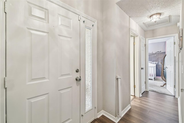 13127 Topflite Ct, Hudson, FL 34669 - entryway featuring wood finished floors, baseboards, and a textured ceiling