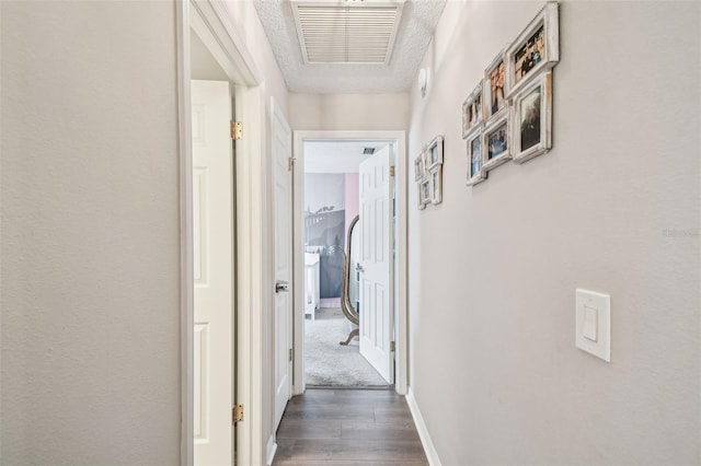 13127 Topflite Ct, Hudson, FL 34669 - corridor with dark wood finished floors, a textured ceiling, and baseboards