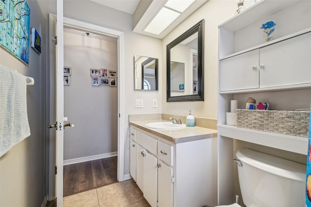 13127 Topflite Ct, Hudson, FL 34669 - bathroom featuring vanity, toilet, and tile patterned floors