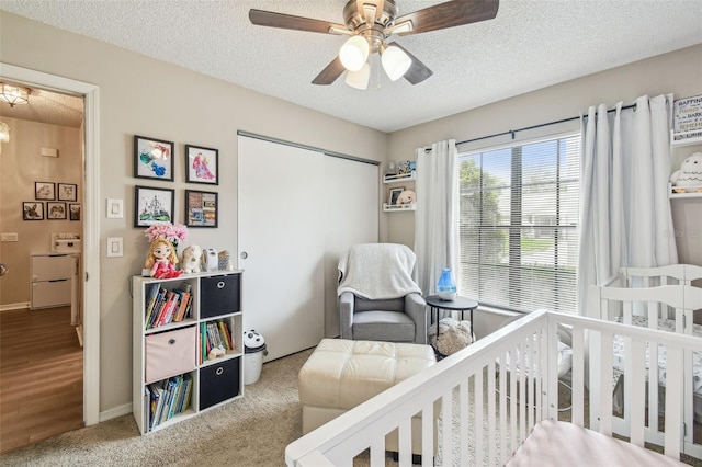 13127 Topflite Ct, Hudson, FL 34669 - carpeted bedroom with a textured ceiling, a closet, ceiling fan, and baseboards