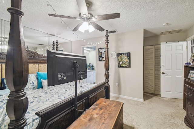 13127 Topflite Ct, Hudson, FL 34669 - bedroom with a textured ceiling, baseboards, carpet flooring, a closet, and a ceiling fan