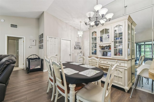 13127 Topflite Ct, Hudson, FL 34669 - dining space with a chandelier, dark wood-style floors, a towering ceiling, and baseboards