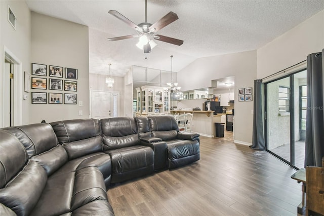 13127 Topflite Ct, Hudson, FL 34669 - living room with ceiling fan, wood finished floors, a chandelier, high vaulted ceiling, and a textured ceiling