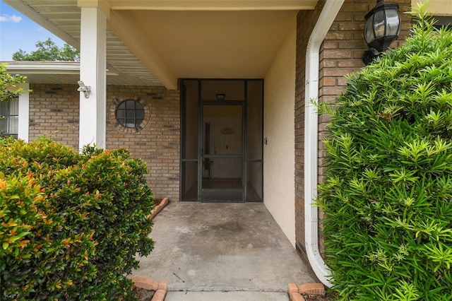 13127 Topflite Ct, Hudson, FL 34669 - doorway to property with brick siding and covered porch