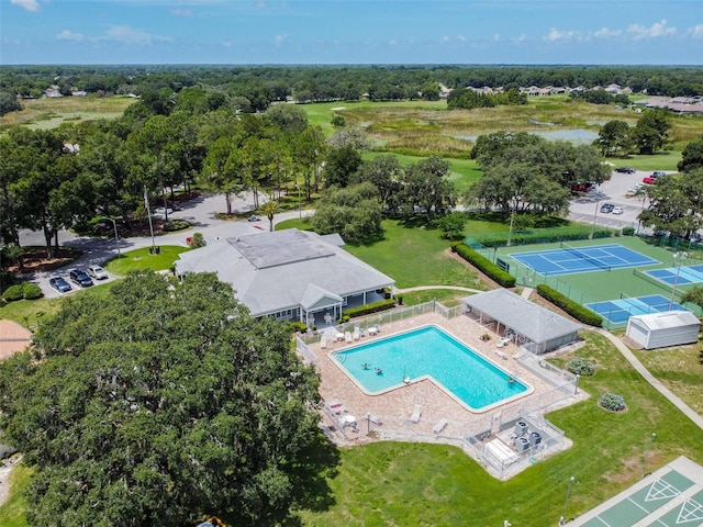 13127 Topflite Ct, Hudson, FL 34669 - drone / aerial view of a pool area and a tree filled landscape