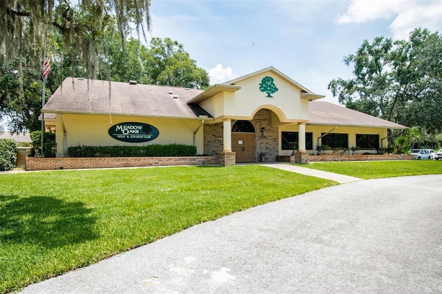 13127 Topflite Ct, Hudson, FL 34669 - view of front of home featuring a front lawn and stucco siding