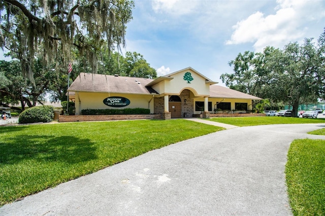 13127 Topflite Ct, Hudson, FL 34669 - view of front of house featuring a front yard, stucco siding, and asphalt driveway