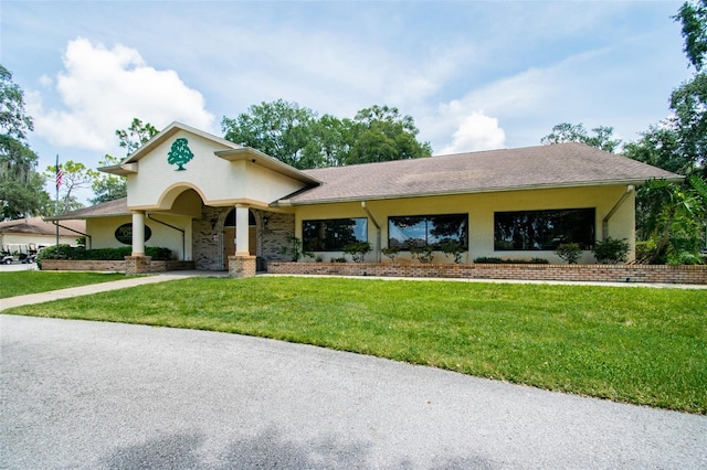 13127 Topflite Ct, Hudson, FL 34669 - view of front facade with a front lawn, stucco siding, a garage, and brick siding