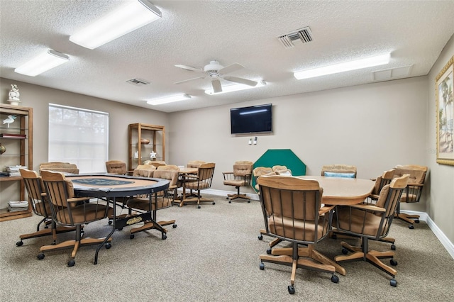 13127 Topflite Ct, Hudson, FL 34669 - recreation room with a textured ceiling, carpet floors, baseboards, and a ceiling fan