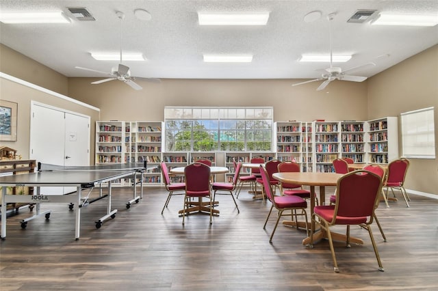 13127 Topflite Ct, Hudson, FL 34669 - dining area featuring a ceiling fan, wood finished floors, and a textured ceiling