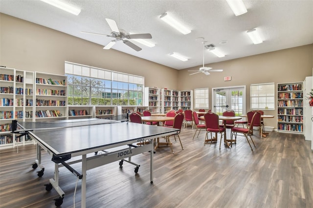 13127 Topflite Ct, Hudson, FL 34669 - rec room with a high ceiling, ceiling fan, a textured ceiling, and wood finished floors