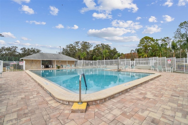 13127 Topflite Ct, Hudson, FL 34669 - community pool featuring a patio and view of scattered trees