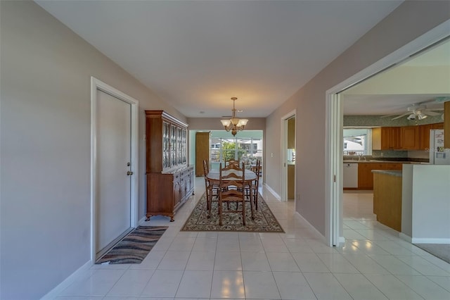 501 Poinsettia Rd, Belleair, FL 33756 - dining room with a chandelier, light tile patterned flooring, baseboards, and ceiling fan
