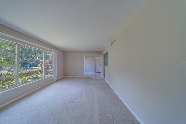 501 Poinsettia Rd, Belleair, FL 33756 - unfurnished room with baseboards and light colored carpet