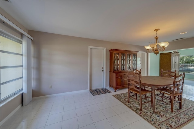 501 Poinsettia Rd, Belleair, FL 33756 - dining room featuring a chandelier and baseboards
