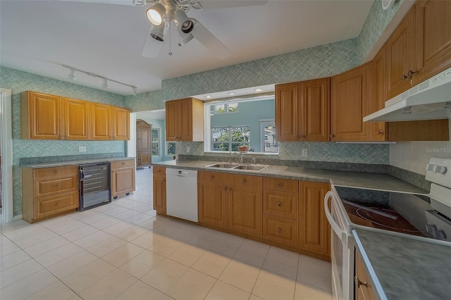 501 Poinsettia Rd, Belleair, FL 33756 - kitchen with white appliances, beverage cooler, a sink, under cabinet range hood, and brown cabinets