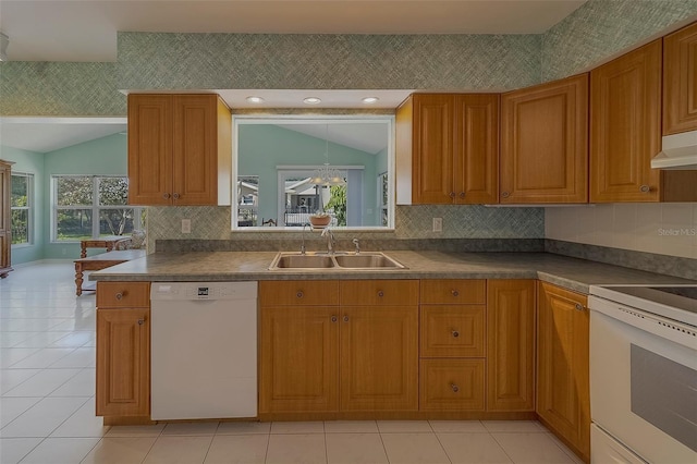 501 Poinsettia Rd, Belleair, FL 33756 - kitchen featuring white appliances, a sink, lofted ceiling, brown cabinets, and light tile patterned floors
