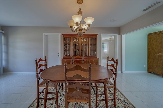 501 Poinsettia Rd, Belleair, FL 33756 - dining area with light tile patterned floors and a chandelier