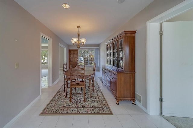 501 Poinsettia Rd, Belleair, FL 33756 - dining room with a chandelier, baseboards, and light tile patterned flooring