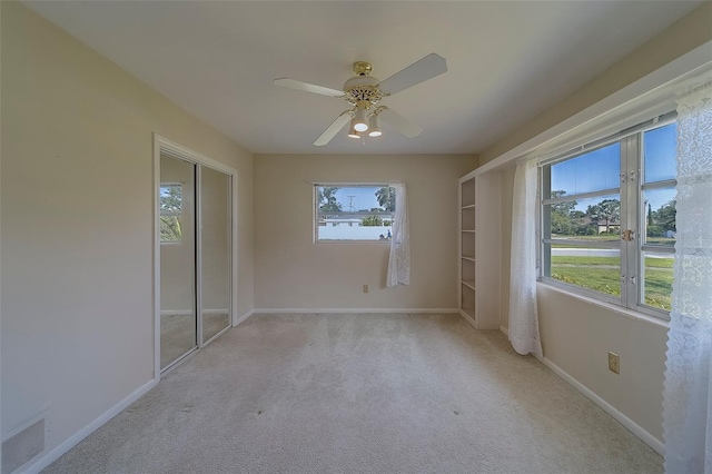501 Poinsettia Rd, Belleair, FL 33756 - unfurnished room featuring light carpet, a ceiling fan, and baseboards