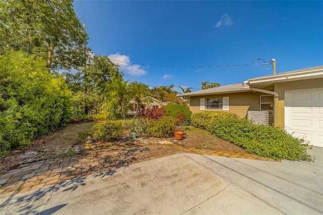 501 Poinsettia Rd, Belleair, FL 33756 - view of yard with an attached garage